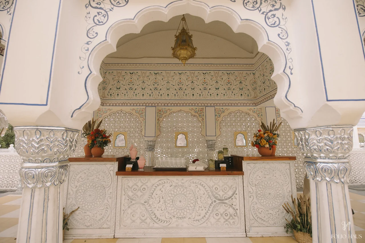 Ornate white and blue courtyard architecture at the Detox Mela.
