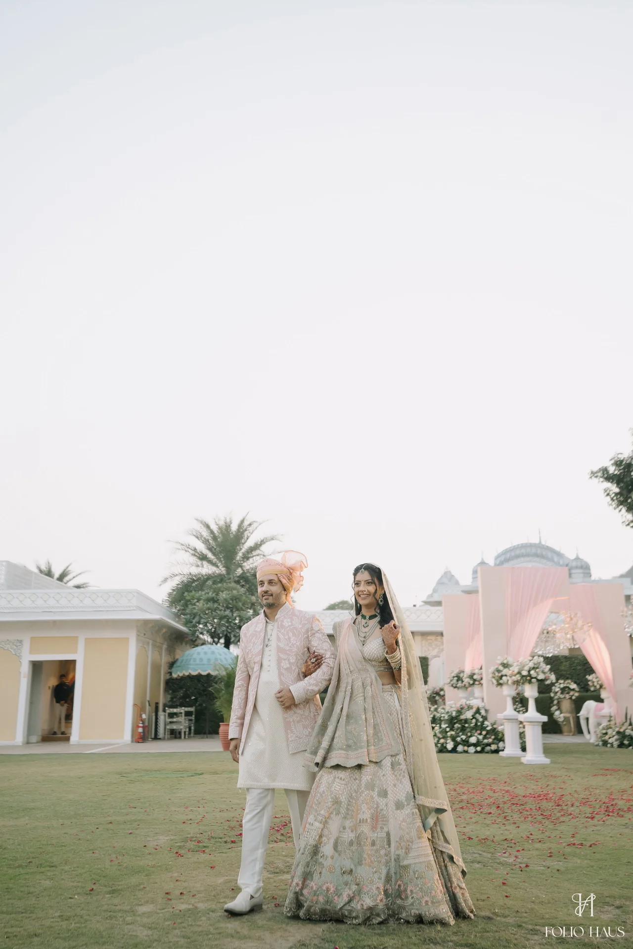 Jigna walking across the lawn in her wedding outfit.